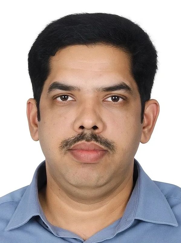 Portrait of a man with a mustache wearing a blue shirt.