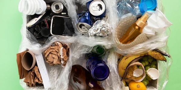 Organized recycling bins with various waste items.