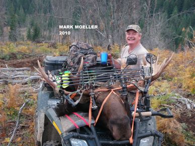 Hunter with a bow and a large elk he hunted in 2010.