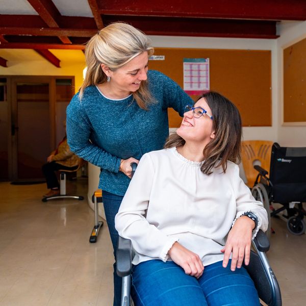 Woman supporting disable woman