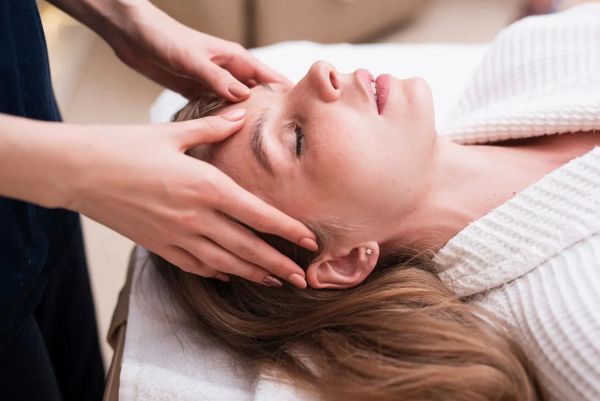 Woman receiving a relaxing head massage.