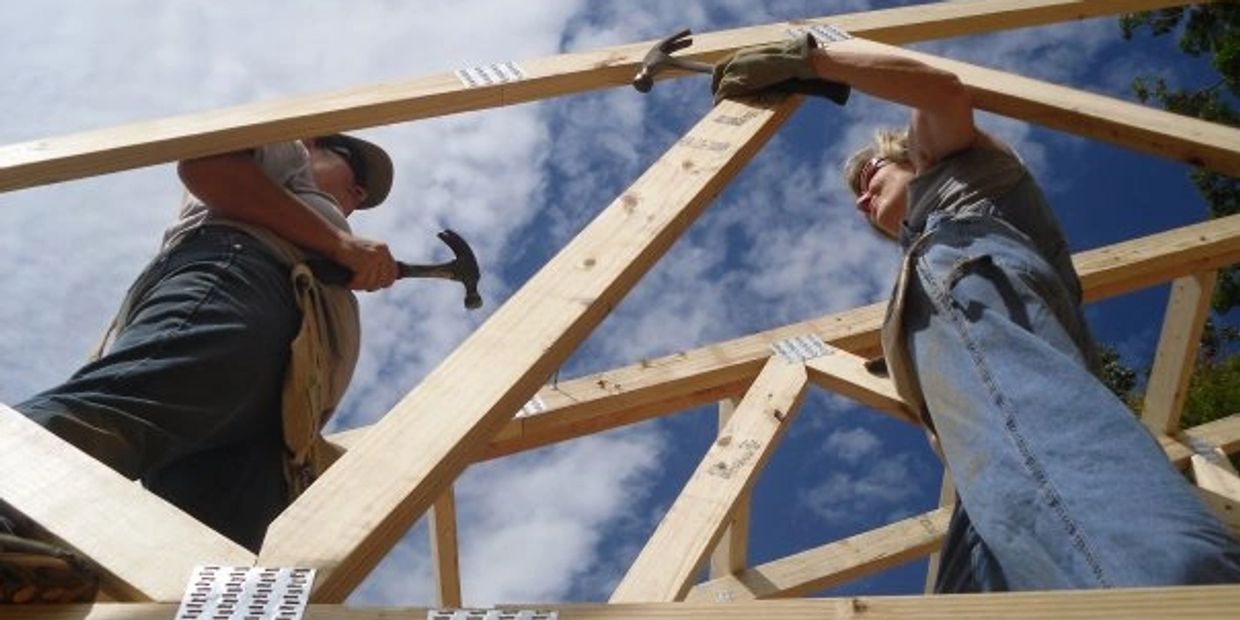 2 women building on a construction site