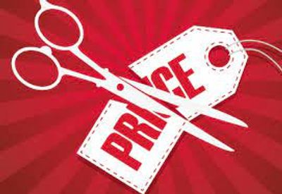 Scissors cutting a price tag symbolizing a price reduction.