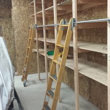 Shop storage with library ladders, a custom install.