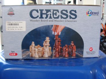 Box of wooden chess set with pieces shown in mid-game setup.