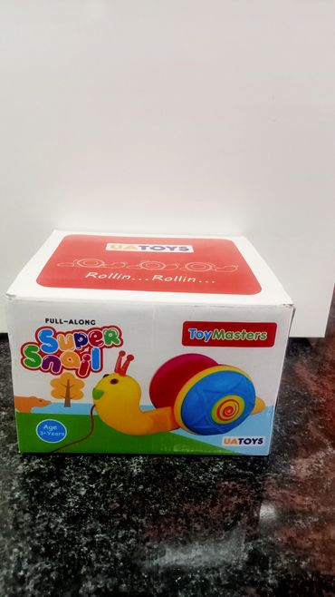 Box of a colorful pull-along toy snail for children.