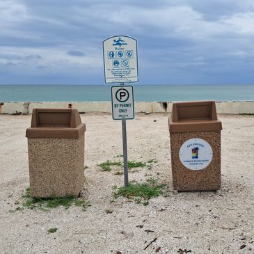 Banyan St. sign, showing 18-12 and 25-16 between Lee County Parks and Recreation trash cans.