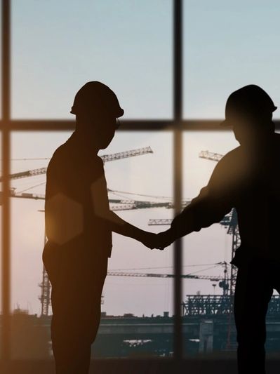 Two construction workers shaking hands 