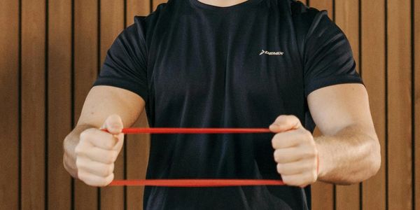 Photo by Pavel Danilyuk: https://www.pexels.com/photo/man-in-black-shirt-using-resistance-band-while