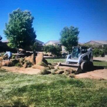 Repairing the sod after regrading the landscape to improve drainage.