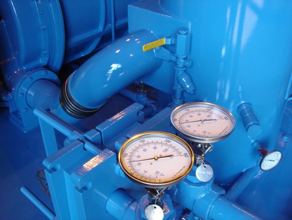 Blue industrial machinery with gauges.