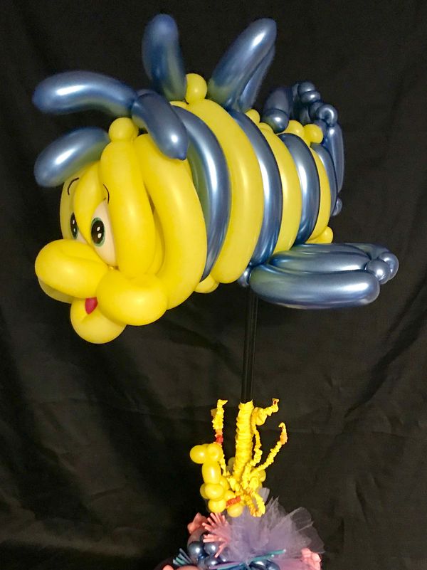 an advance balloon fish swimming over a coral reef  made of balloons