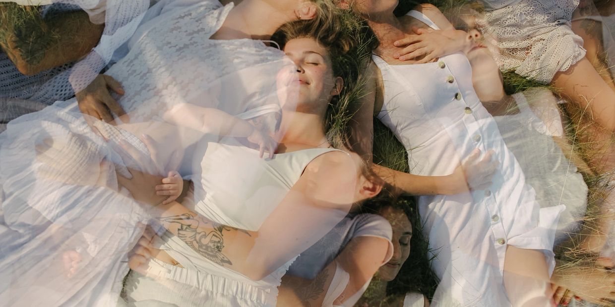 Overlay of people lying peacefully on grass.