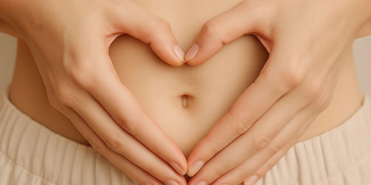a woman's belly with heart shape hands