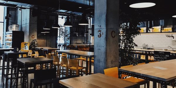 A community restaurant with tables and chairs.