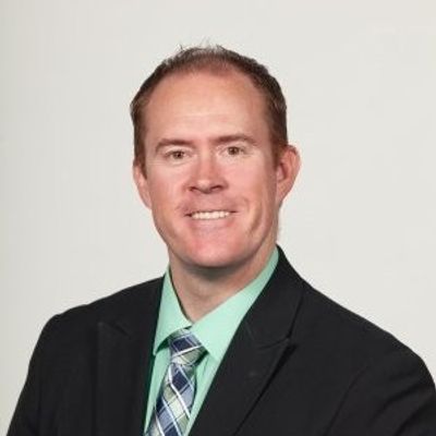 Professional portrait of a man in a suit and tie.
