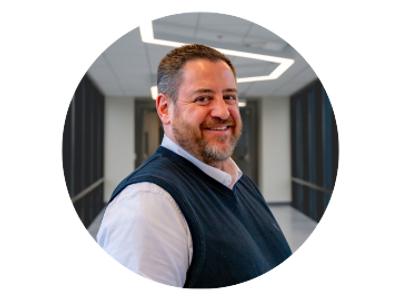Smiling man in business casual attire.