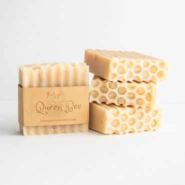 Natural honeycomb-patterned soap bars with a Queen Bee label.