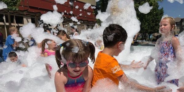 Children play in foam at bay area foam parties