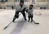 Derick Schmidt and his little Yeti, Jeremiah, take in some stick time together in their official Yetis jerseys.