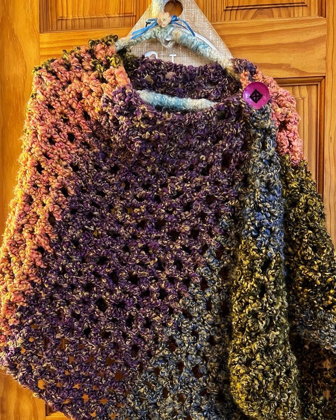 Multi-colored and multipurpose! Stay warm and happy in this shawl, poncho, scarf. 