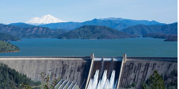 Mt. Shasta in the background with a view of Shasta Lake and Shasta Dam.