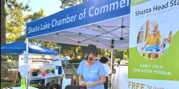 Community event booth promoting early childhood education by Shasta Lake Chamber of Commerce.