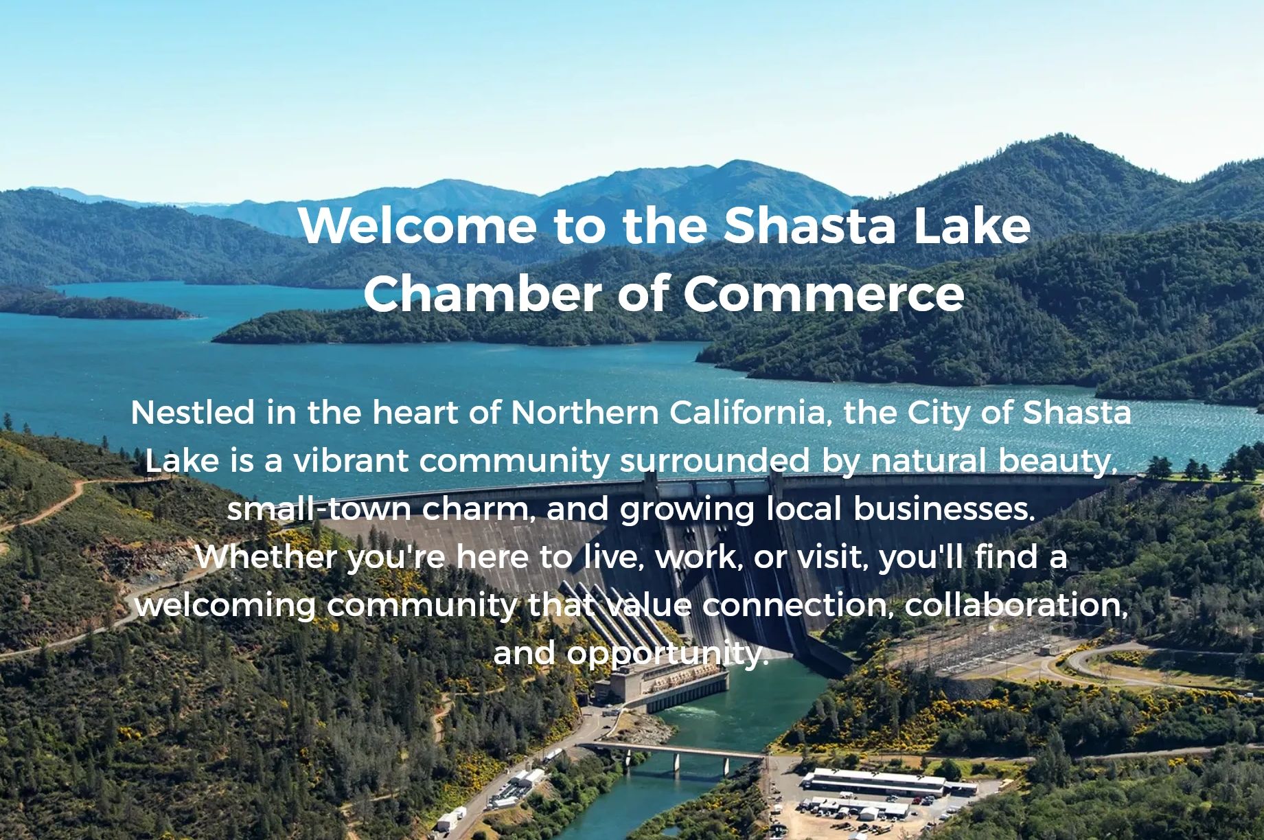 View of Shasta Lake and Dam with mountains on the background.
