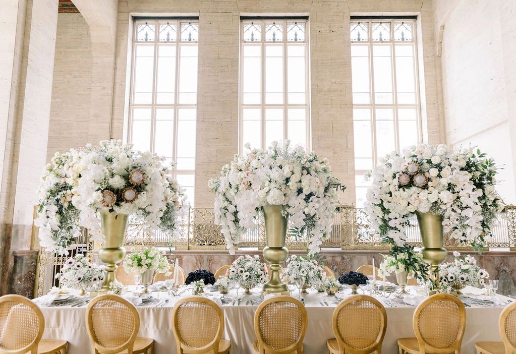 Wedding florals set up on reception dinner table ready for guests. 