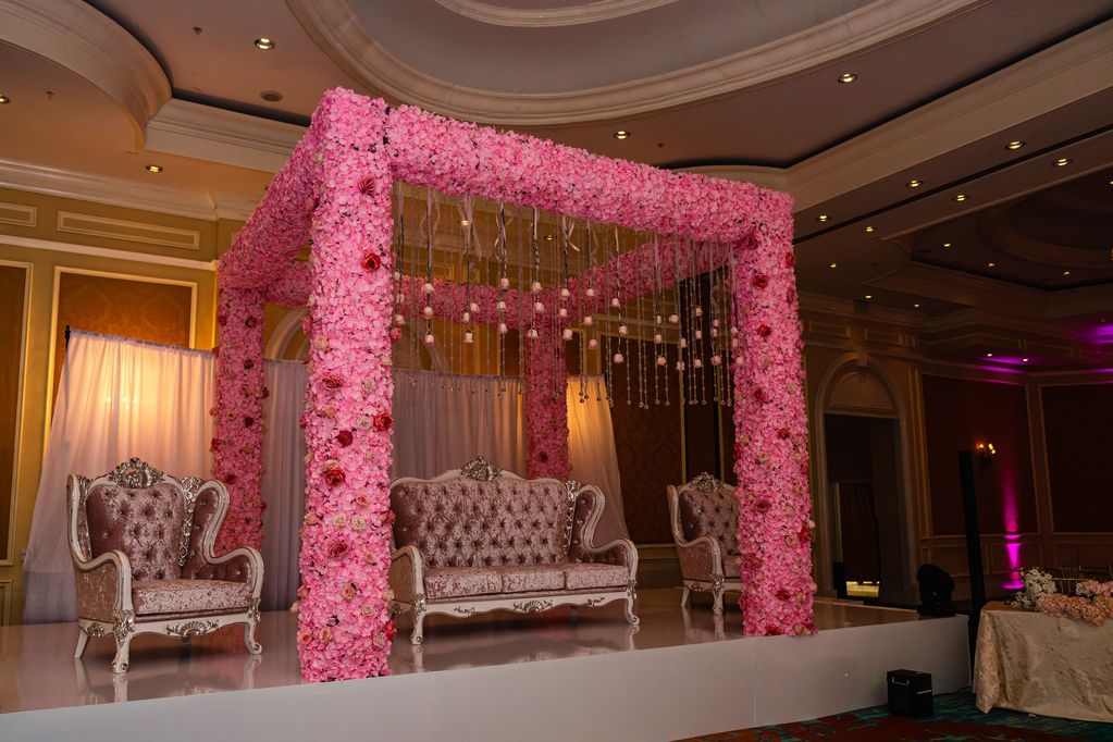 Floral event set up with large chairs and overhang. 