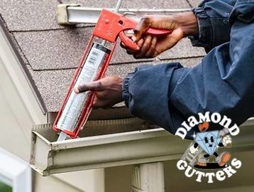 "Technician sealing gutters to prevent leaks. Diamond Gutters serves D.C. Maryland, and Virginia