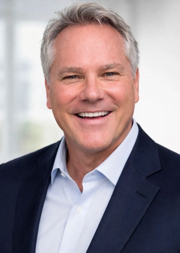 Smiling middle-aged man in business attire.