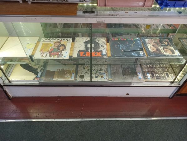 Looking down at a display case with vintage records inside.