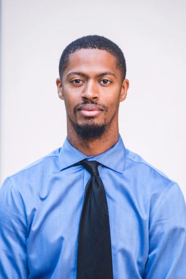 Man in blue shirt and black tie.