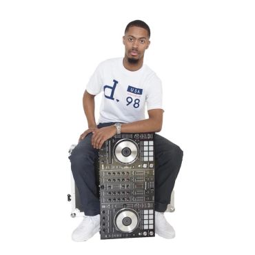 Man sitting holding a DJ controller.
