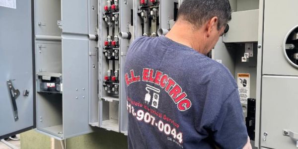 Electrician working on an electrical panel.
