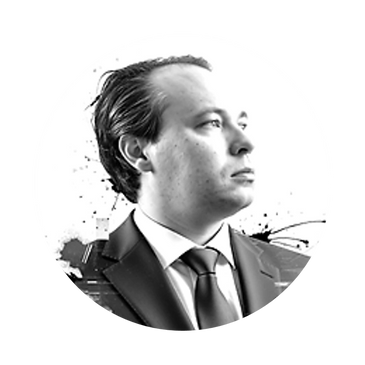 Black and white portrait of a man in a suit looking contemplative.