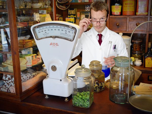 A chemist in a shop selling chemicles