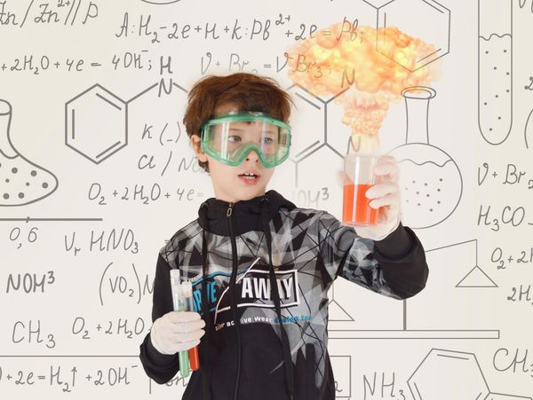 A kid demonstrating chemistry