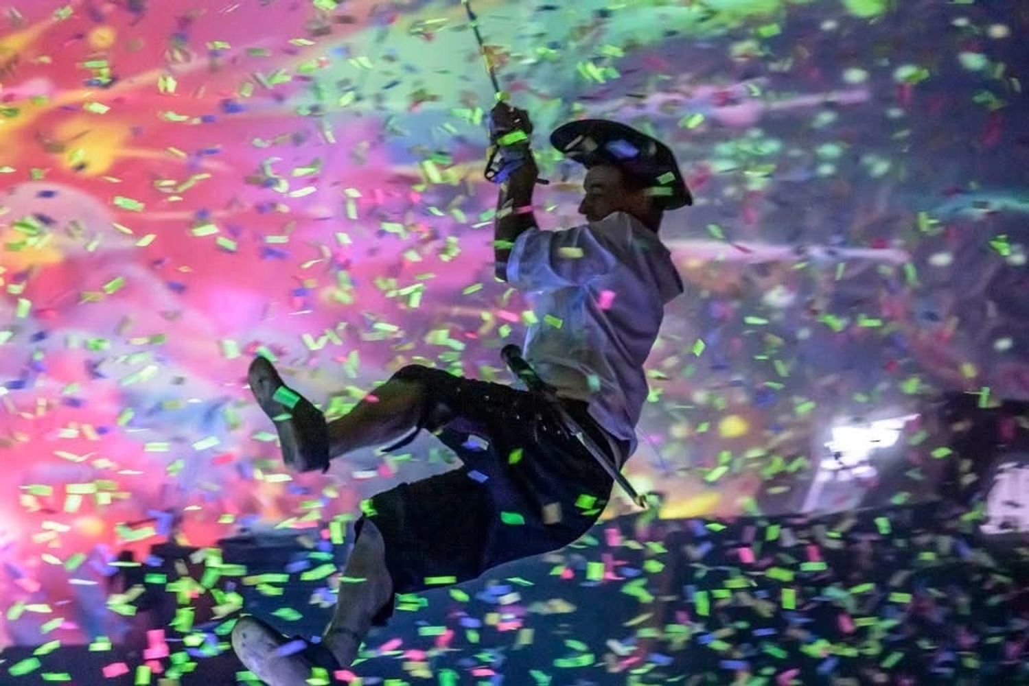 colorful confetti Captain Boon swinging from boat to boat