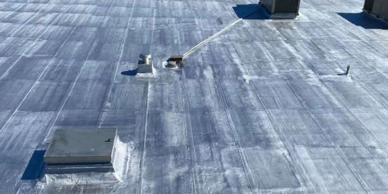 Flat roof with various vents and pipes.