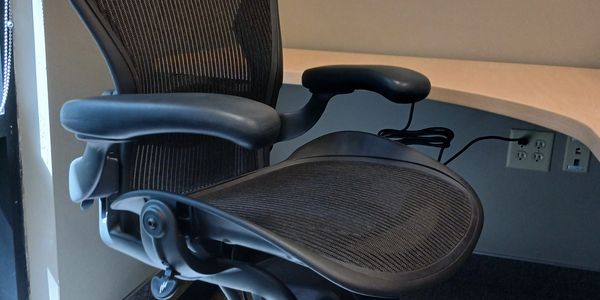Ergonomic office chair near a desk in a workspace.
