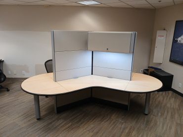 Modern office cubicle desk with divider.