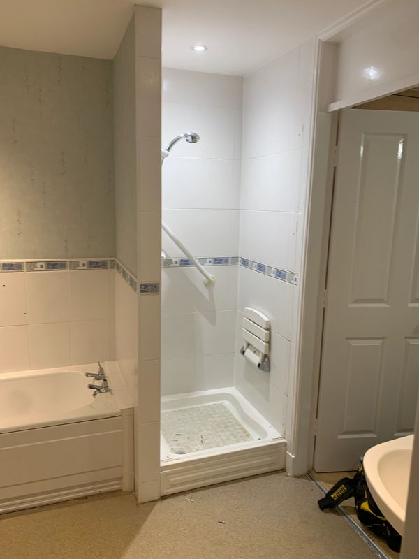 Small bathroom with a shower, bathtub, and sink.