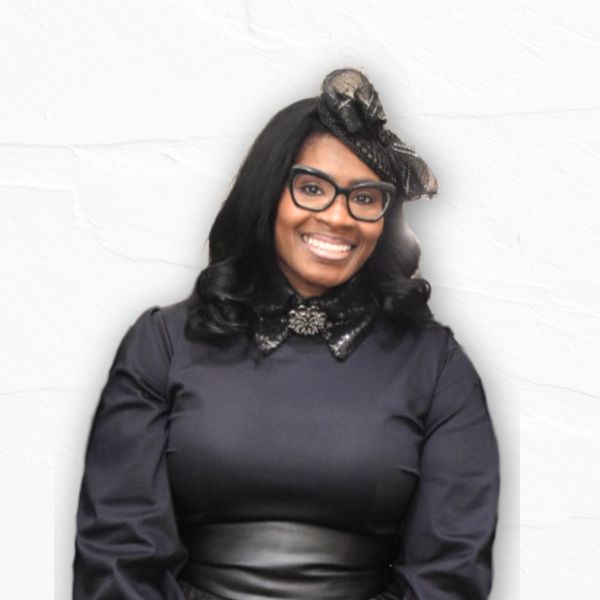 Smiling woman with glasses and black outfit.