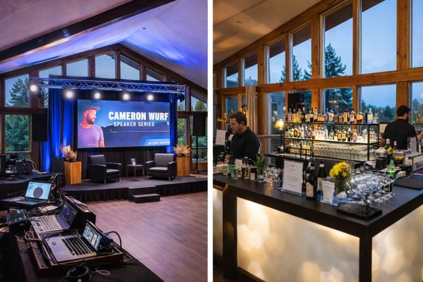 Event space with a speaker stage and a modern bar area with large windows.