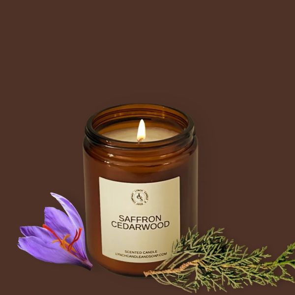 Saffron CedarWood candle displayed next to the candle on a cedar wood block with saffron flowers.