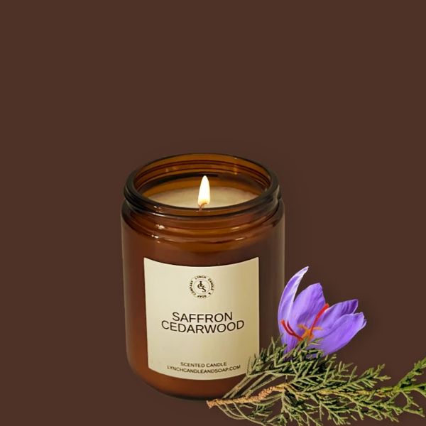 Saffron CedarWood candle displayed next to the candle on a cedar wood block with saffron flowers.