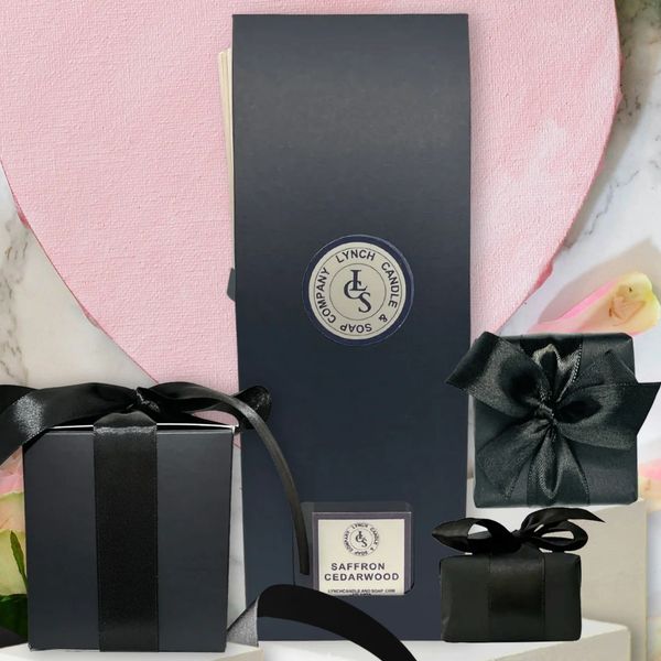 All natural handmade product, reed diffuser, candle and soap wrapped in black paper and black ribbon