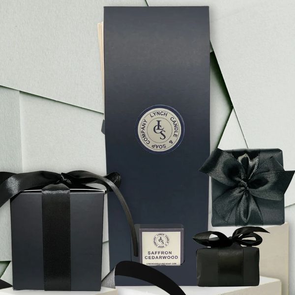 All natural handmade product, reed diffuser, candle and soap wrapped in black paper and black ribbon